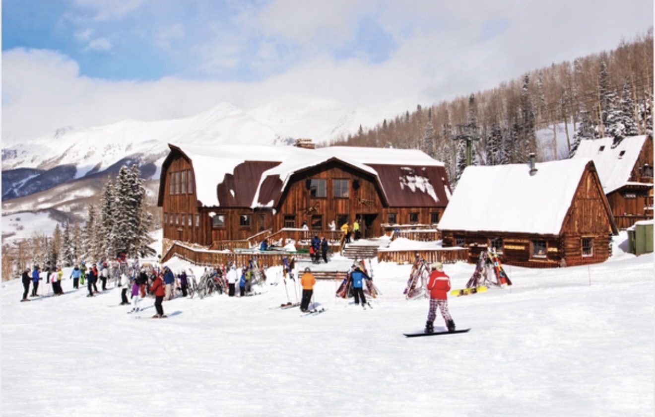 Gorrono Ranch seen from the ski run, skiers gathered outside the lodge
