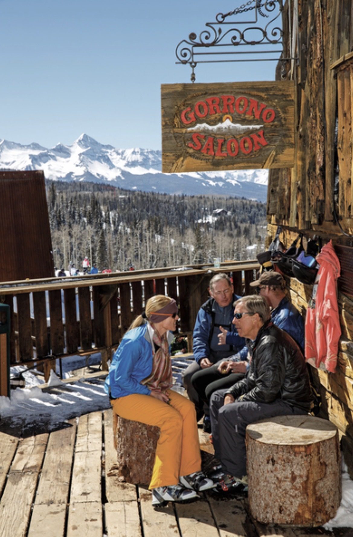 The carved Gorrono Saloon sign hanging on the weathered timber wall, the Wilson Range behind the deck