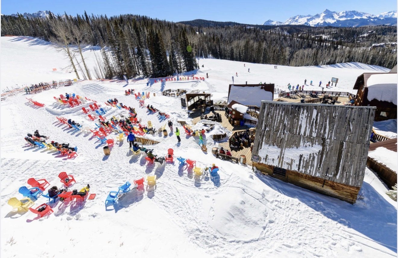 Snow Beach at Gorrono Ranch from above, rows of coloured chairs across the snow